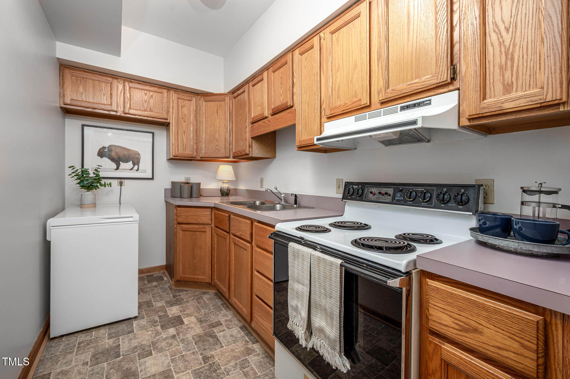 7723 Johnson Mill Road Bahama, NC 27503 - Photo 32 of 58 a kitchen with stainless steel appliances granite countertop a stove a sink and a refrigerator