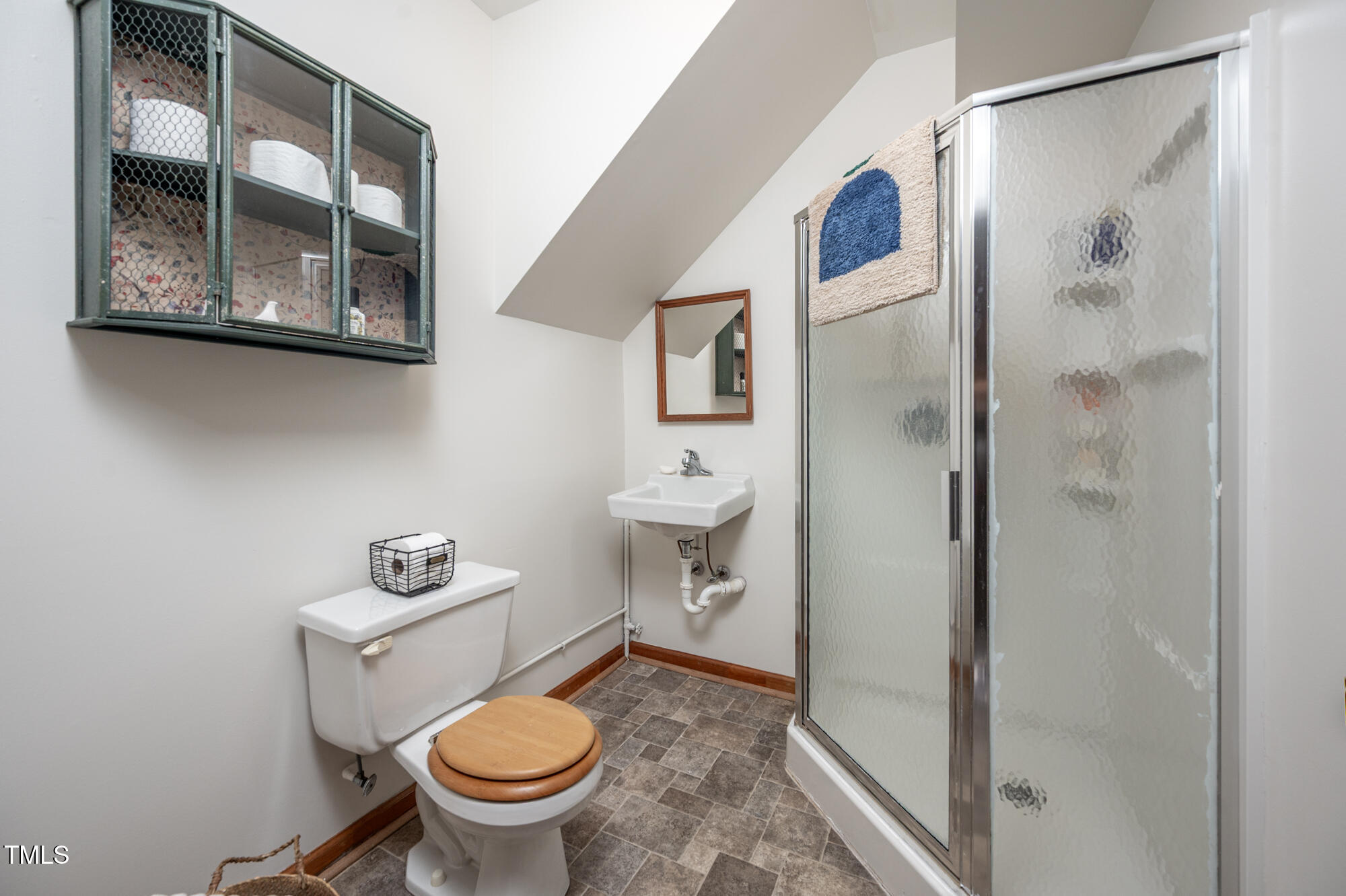 7723 Johnson Mill Road Bahama, NC 27503 - Photo 36 of 58 a white toilet sitting next to a bathroom shower and a sink