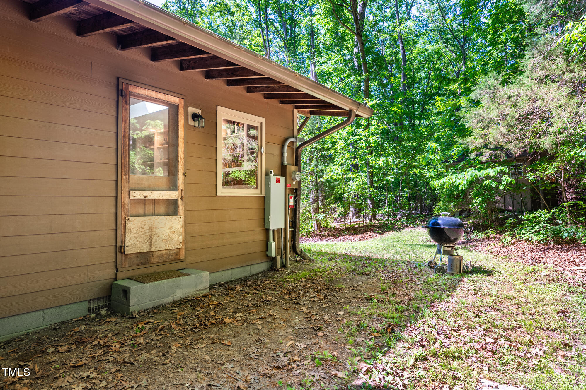 7723 Johnson Mill Road Bahama, NC 27503 - Photo 42 of 58 a backyard of a house with barbeque oven