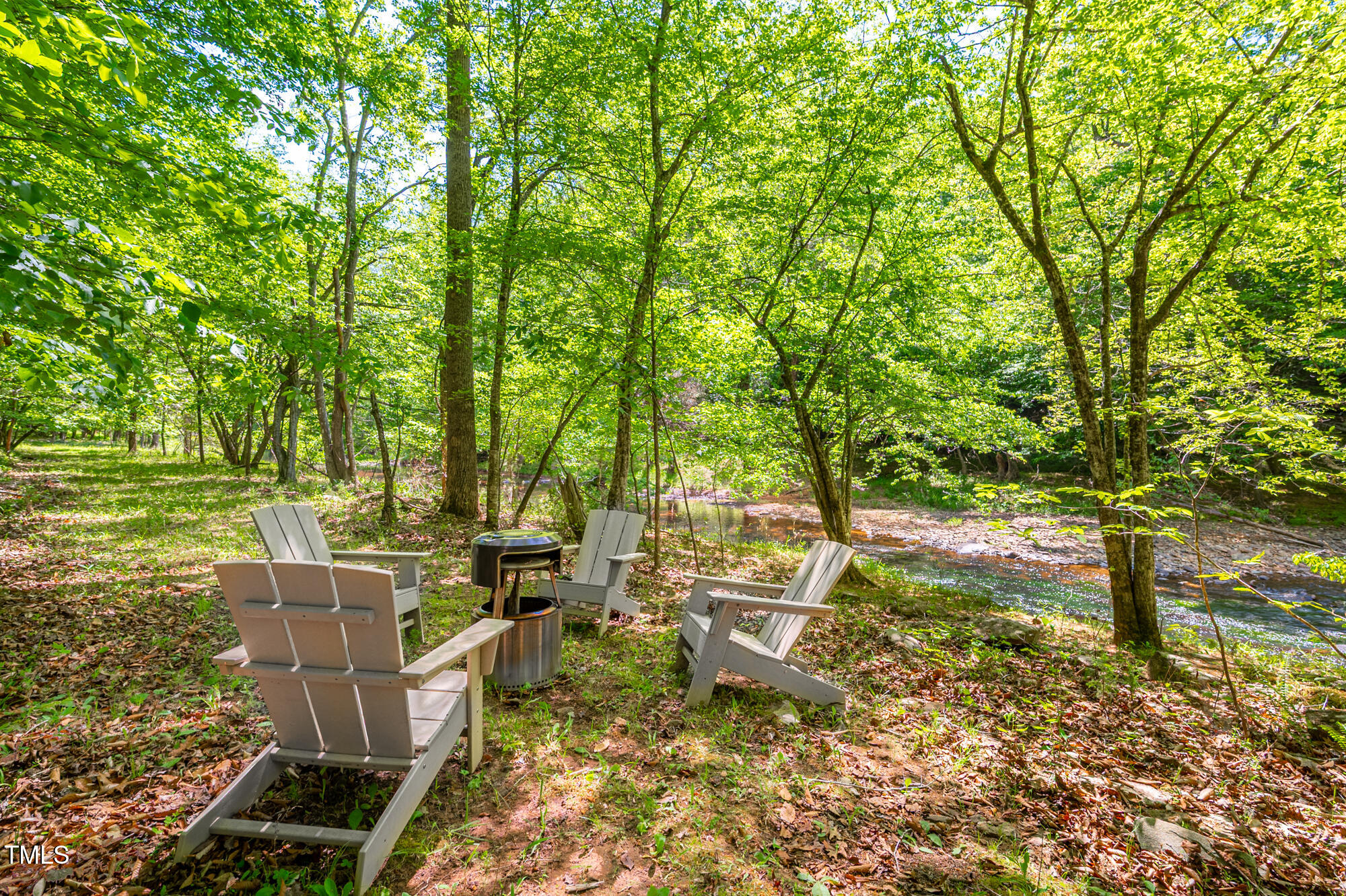 7723 Johnson Mill Road Bahama, NC 27503 - Photo 48 of 58 a backyard of a house with table and chairs