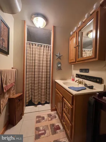 a kitchen that has a sink a stove and a mirror