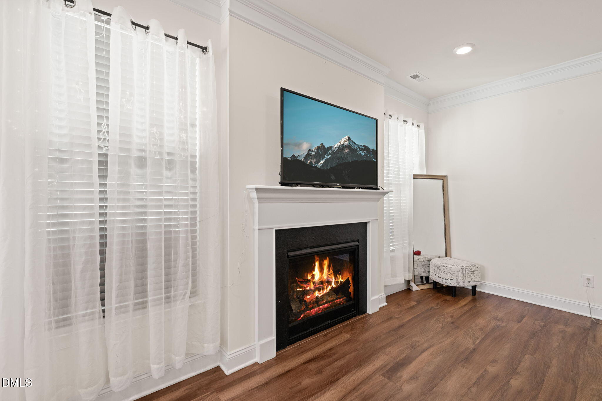 94 Combine Trail Benson, NC 27504 - Photo 13 of 43 a living room with furniture a fireplace and a flat screen tv