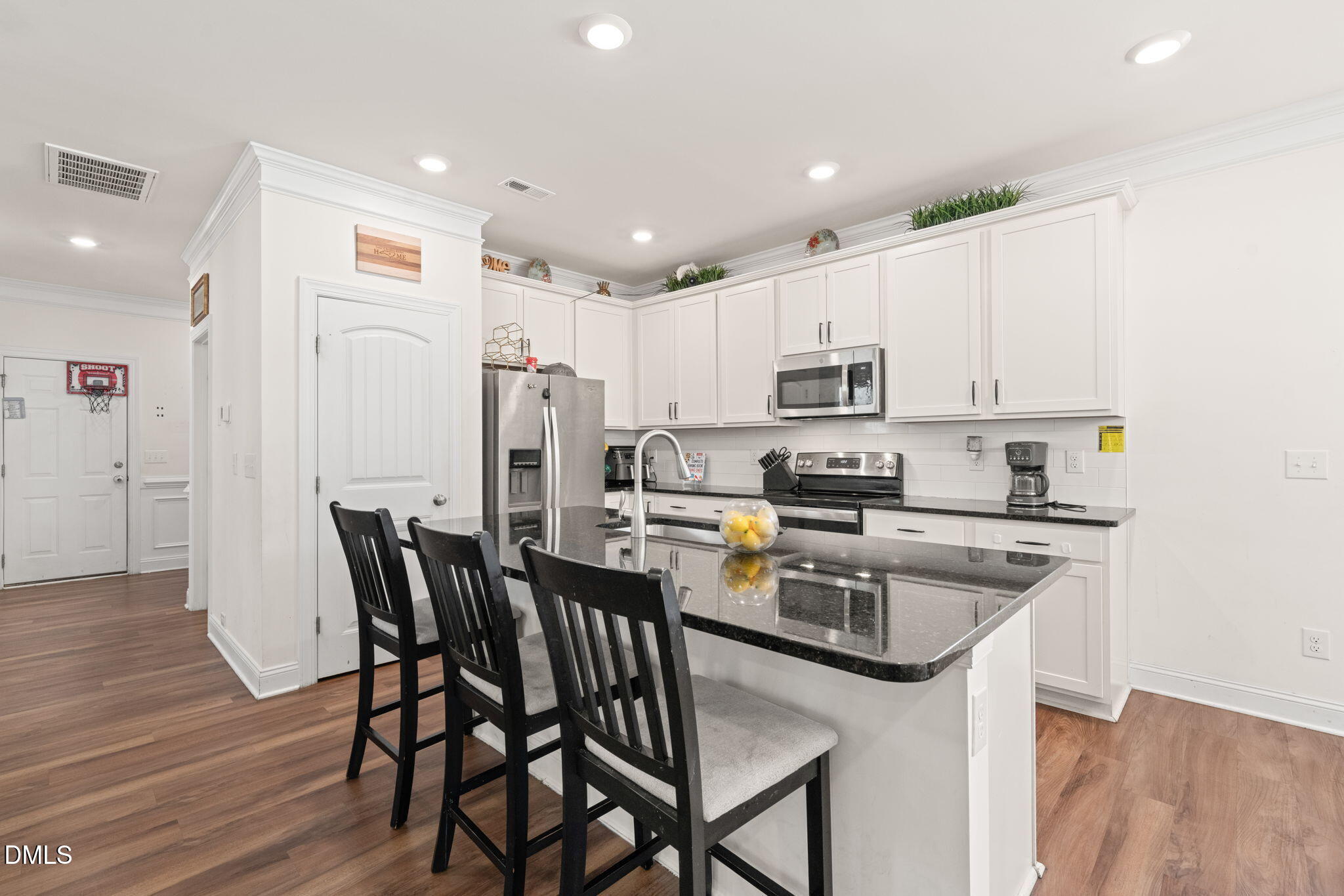94 Combine Trail Benson, NC 27504 - Photo 7 of 43 a kitchen with stainless steel appliances granite countertop a dining table chairs refrigerator and microwave