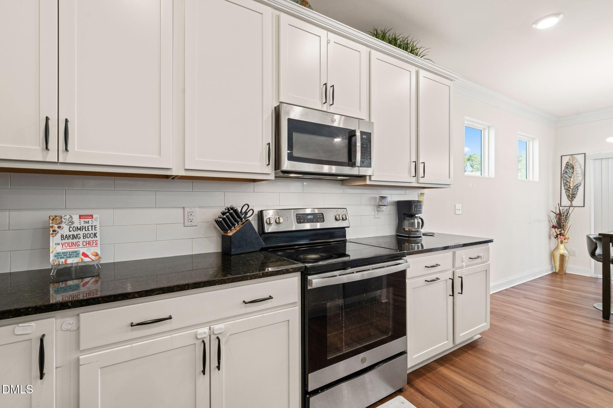 94 Combine Trail Benson, NC 27504 - Photo 9 of 43 a kitchen with granite countertop white cabinets and stainless steel appliances