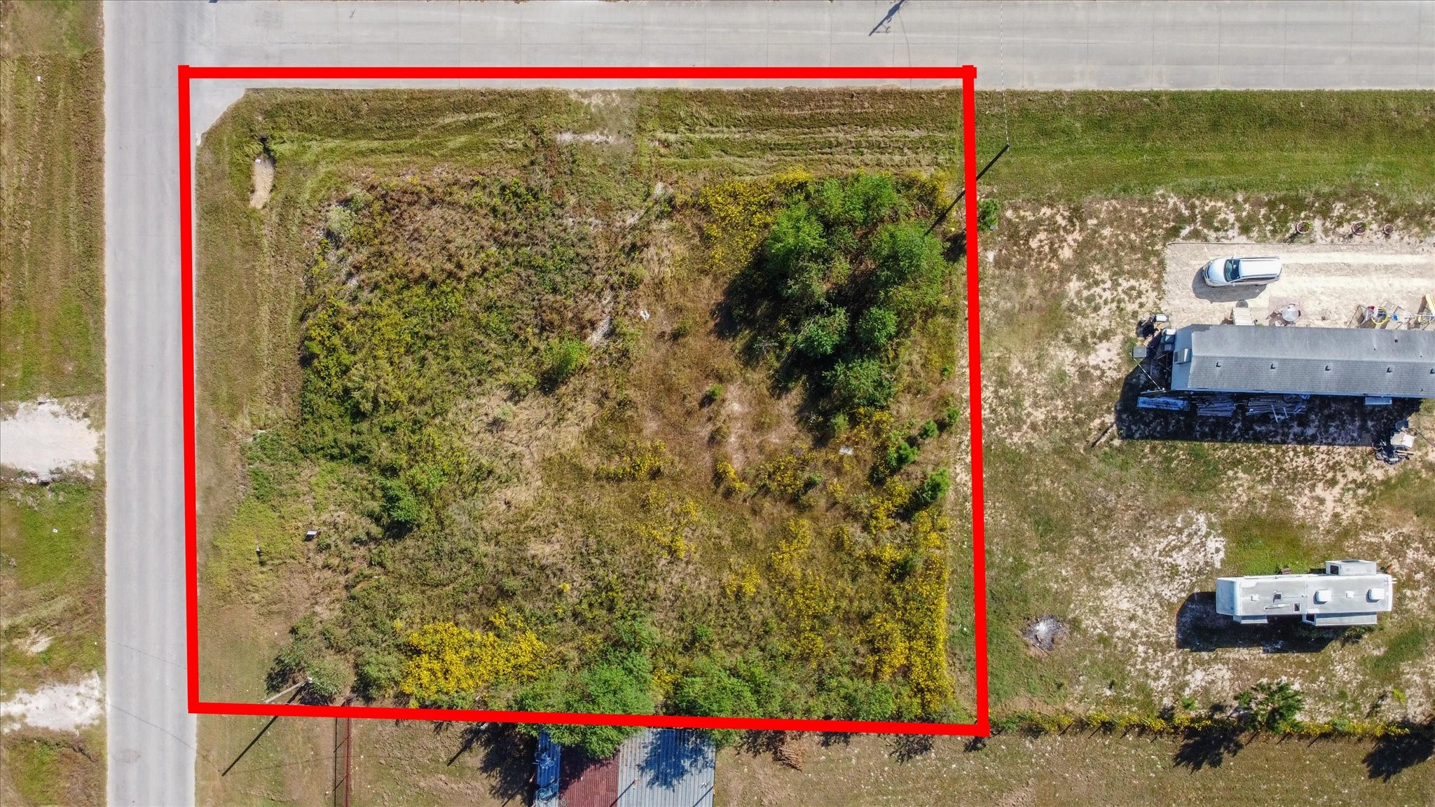 346 County Road 3550 Cleveland, TX 77327 - Photo 2 of 14 The terrain appears mostly flat and grassy, and the property is situated near paved roads with easy access to the surrounding neighborhood.