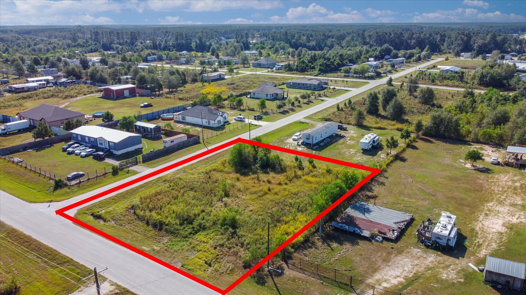 346 County Road 3550 Cleveland, TX 77327 - Photo 3 of 14 Close-up of the flat, cleared ground, highlighting the clean, ready-to-build condition. Includes two 30-foot driveways, emphasizing easy entry and exit from the property.