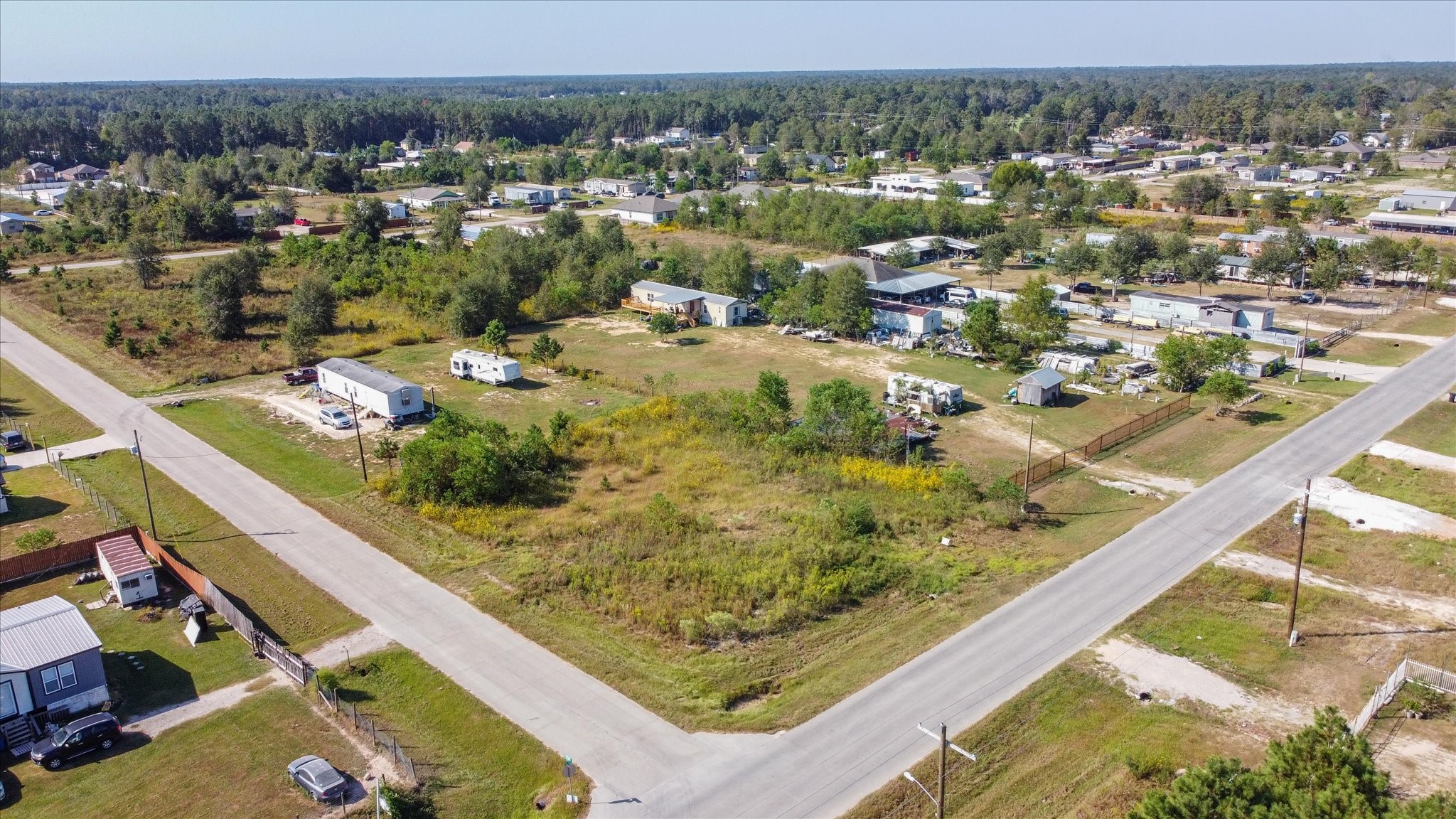 346 County Road 3550 Cleveland, TX 77327 - Photo 4 of 14 Front view of the lot from the adjacent residential street, illustrating its visibility and accessibility.