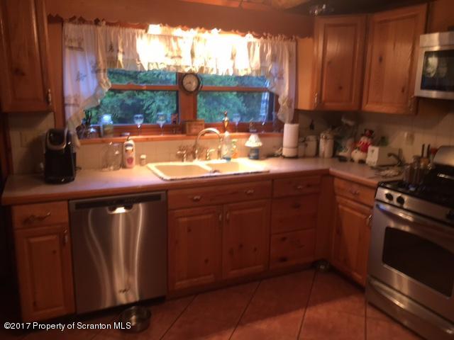 439 Freeman Road Dalton, PA 18414 - Photo 10 of 33 a kitchen with stainless steel appliances granite countertop a sink stove and cabinets