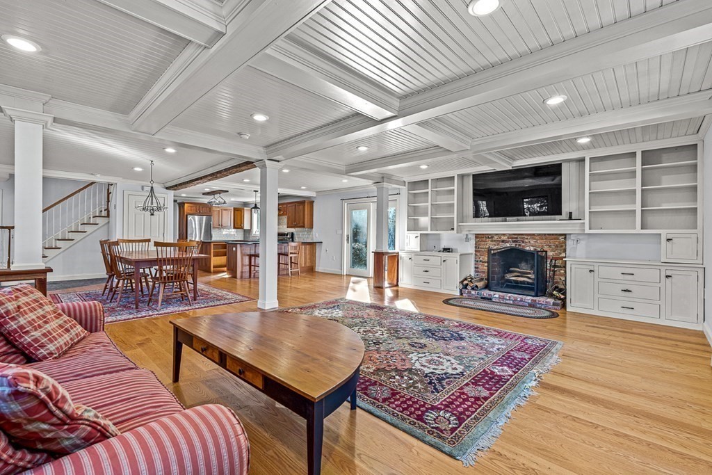 140 Forest Street Middleton, MA 01949 - Photo 3 of 32 a living room with furniture a flat screen tv and a fireplace