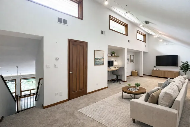 a room with furniture a table and large windows