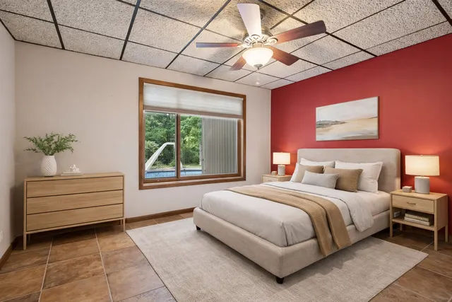 a bedroom with a bed and a window