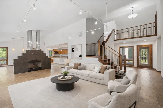 a kitchen with kitchen island granite countertop a stove and a sink