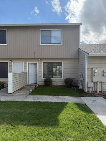 a front view of a house with a garden and yard