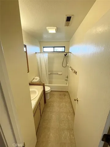 a bathroom with a shower and a sink
