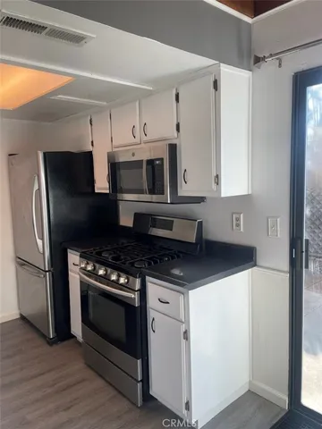 a kitchen with stainless steel appliances a stove a microwave and a refrigerator