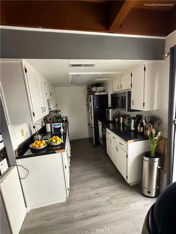 a kitchen with stainless steel appliances granite countertop a refrigerator and a stove