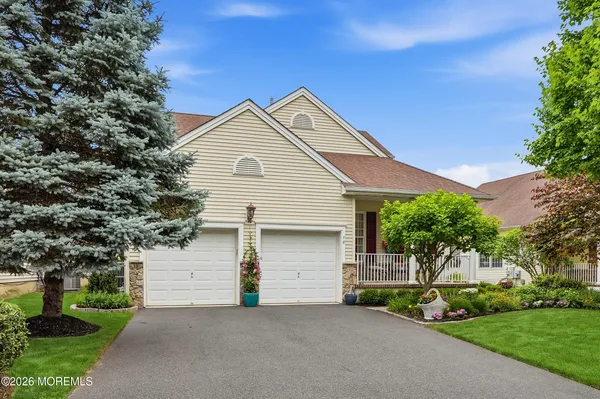 a view of a house with a yard and garage