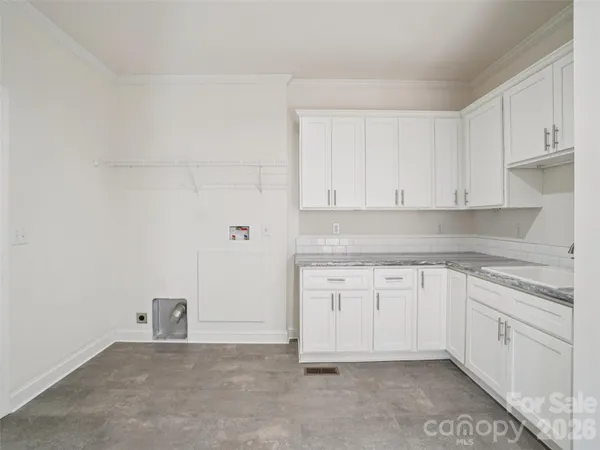 a kitchen with white cabinets
