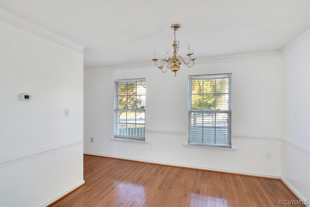 2931 Heather Ridge Drive Henrico, VA 23231 - Photo 14 of 30 an empty room with wooden floor chandelier and windows
