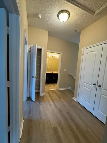 a view of a hallway with wooden floor