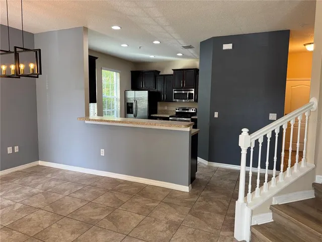 a view of a kitchen with a sink and cabinets