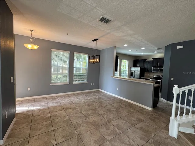 a view of a kitchen with furniture and a window