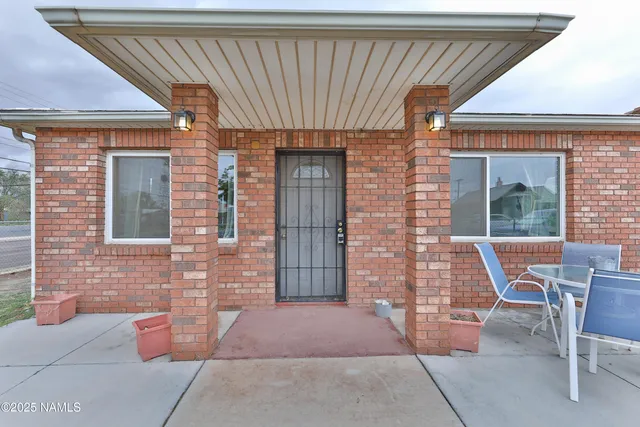 a front view of a house with outdoor seating