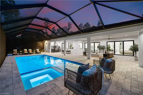 a view of a patio with swimming pool table and chairs