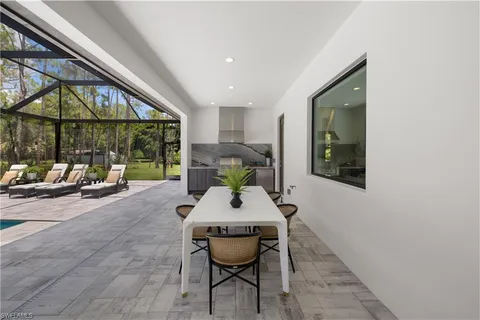 a room with furniture and large windows
