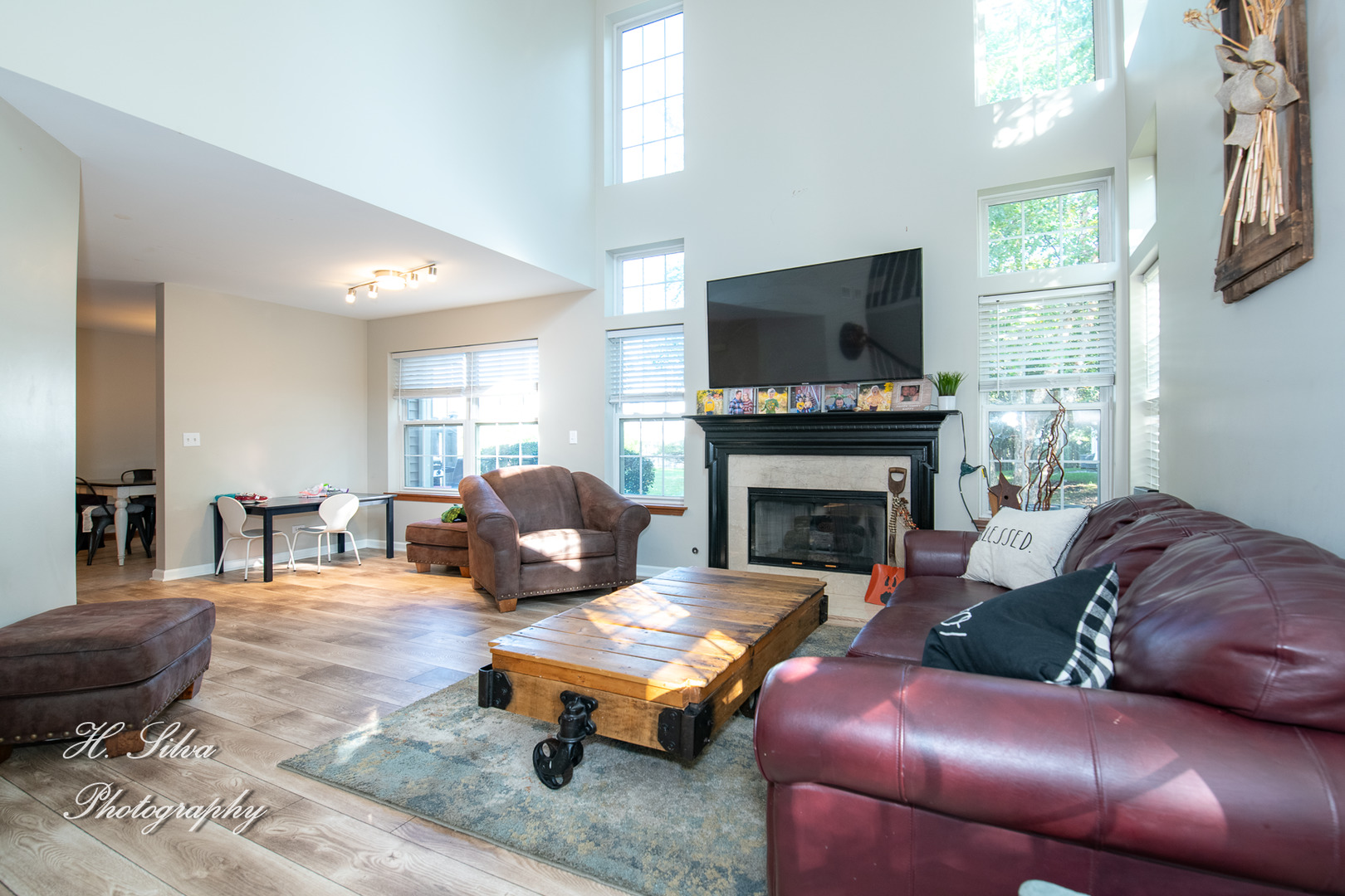 9530 Rainsford Drive Huntley, IL 60142 - Photo 2 of 14 a living room with furniture a flat screen tv and a fireplace