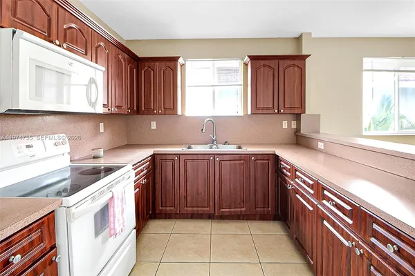 a kitchen with a stove a sink and a microwave