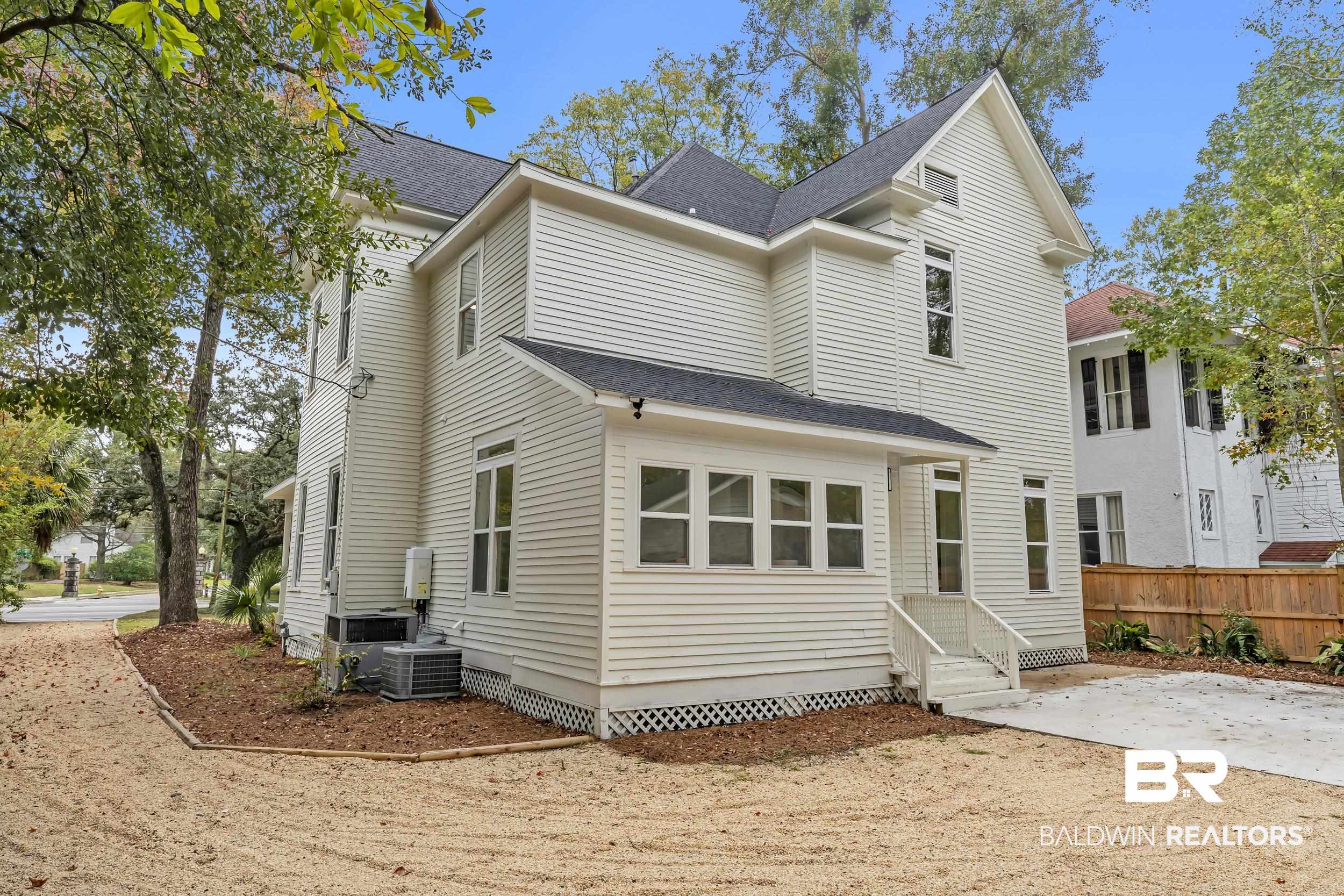 1662 Government Street Mobile, AL 36604 - Photo 32 of 33 Rear view of property with a shingled roof and entry steps