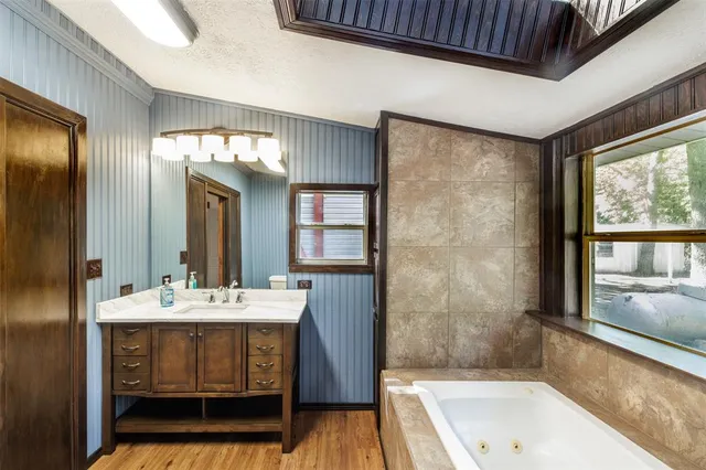 a bathroom with a sink a mirror and a bathtub