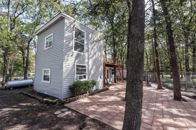 a view of a house with a yard and tree s