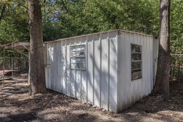 a view of a wooden door in the backyard