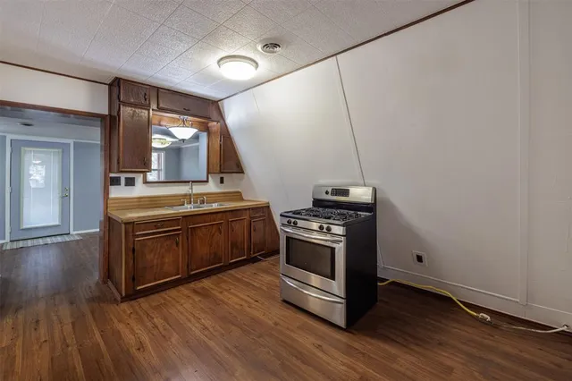 a kitchen with granite countertop wooden floors and stainless steel appliances