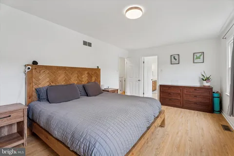 a bedroom with a bed and a dresser