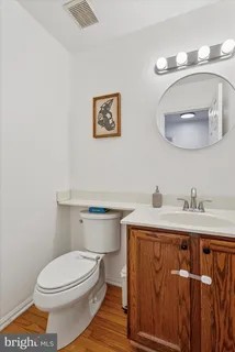 a bathroom with a toilet a sink and mirror