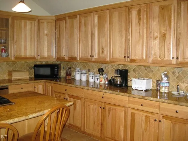 a kitchen with stainless steel appliances white cabinets and a refrigerator