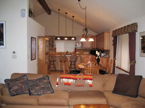 a living room with furniture and a chandelier