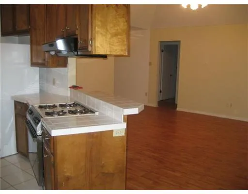a kitchen with a stove and a kitchen view