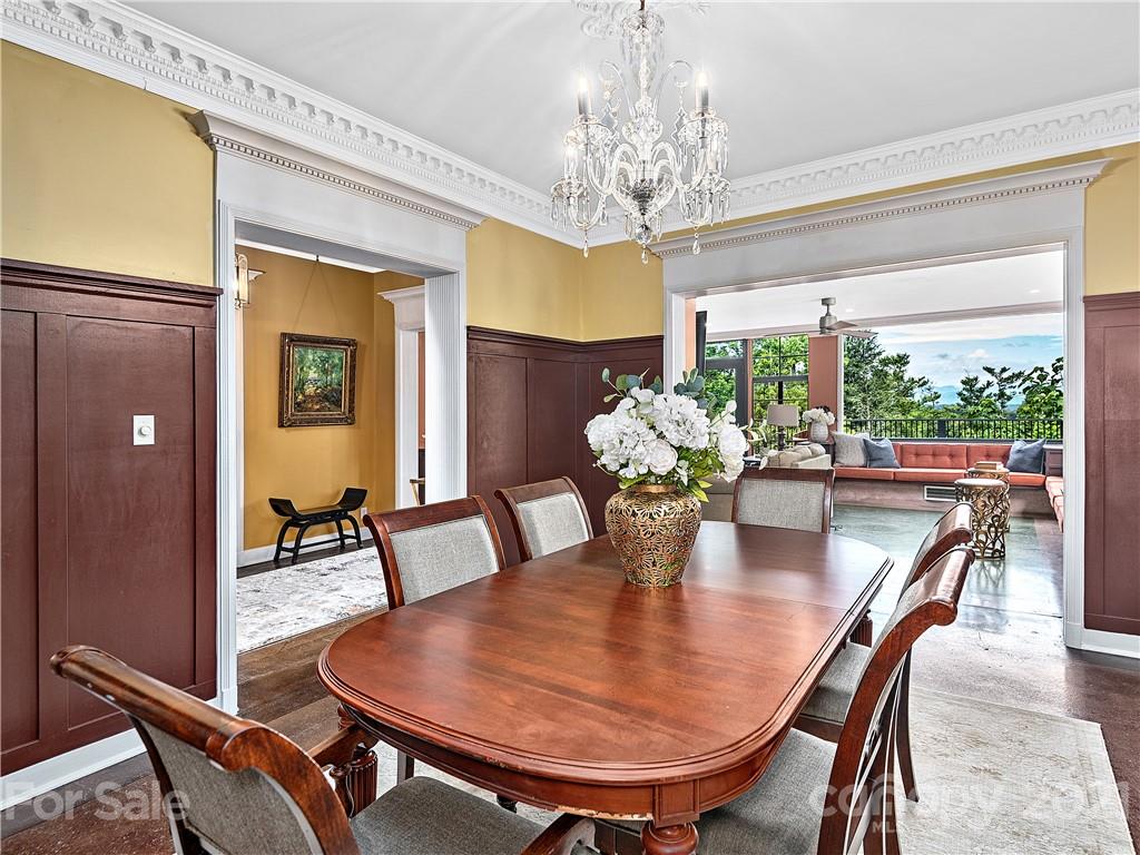 930 Country Club Road Asheville, NC 28804 - Photo 11 of 47 a view of a dining room with furniture a chandelier and wooden floor