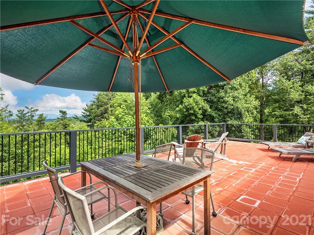930 Country Club Road Asheville, NC 28804 - Photo 14 of 47 an outdoor space with furniture and umbrella