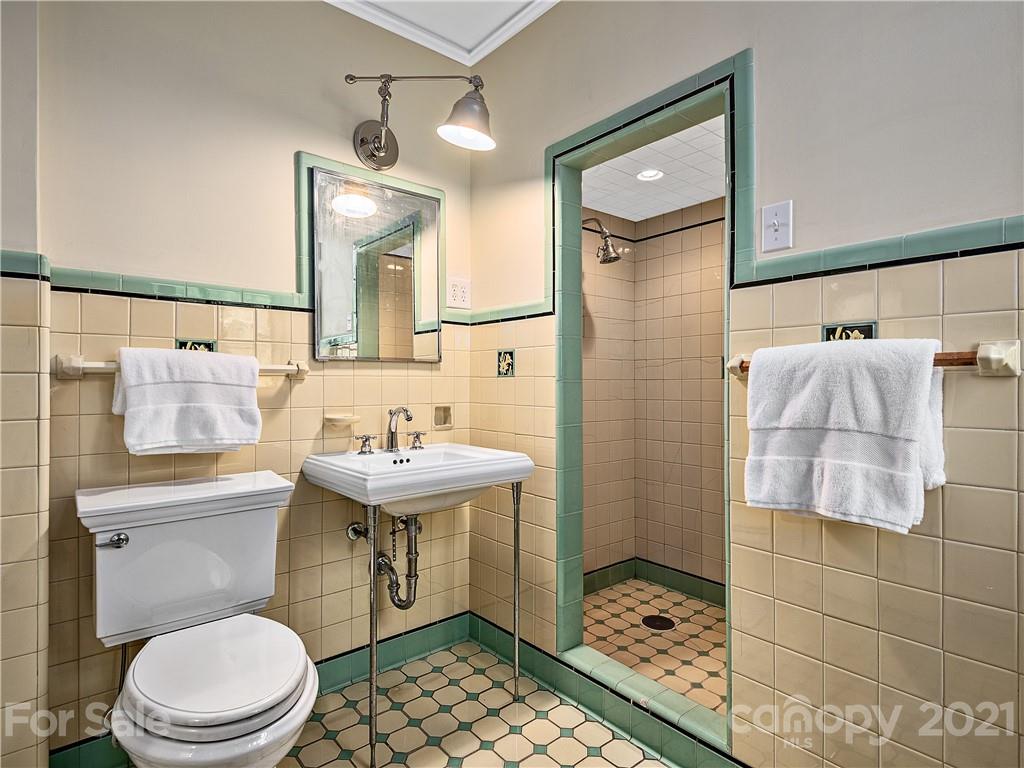 930 Country Club Road Asheville, NC 28804 - Photo 16 of 47 a bathroom with a sink a toilet and shower