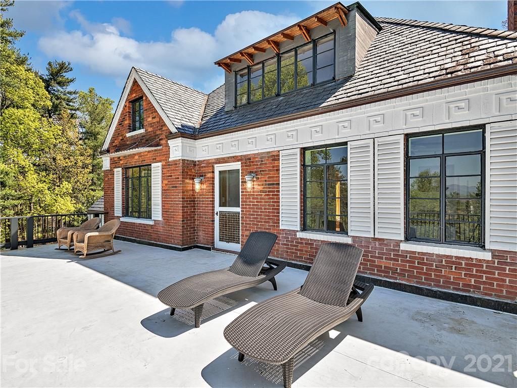 930 Country Club Road Asheville, NC 28804 - Photo 20 of 47 a view of a lounge chair in front of house