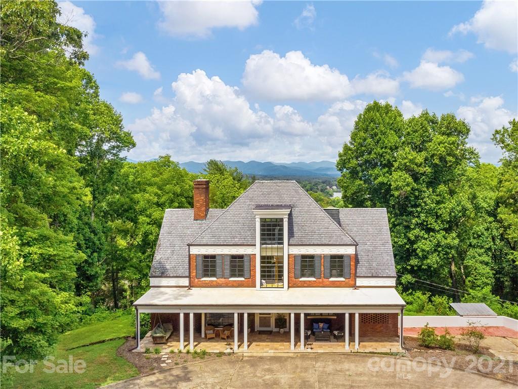 930 Country Club Road Asheville, NC 28804 - Photo 3 of 47 a front view of a house with a garden and trees