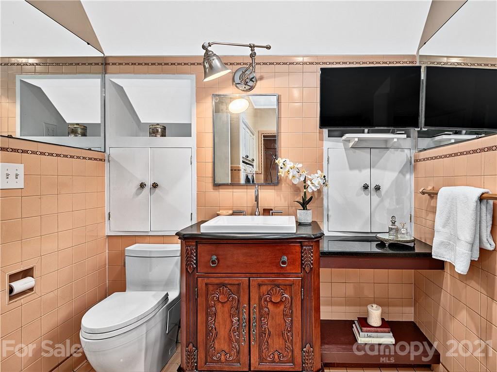 930 Country Club Road Asheville, NC 28804 - Photo 23 of 47 a bathroom with a sink a toilet and a mirror