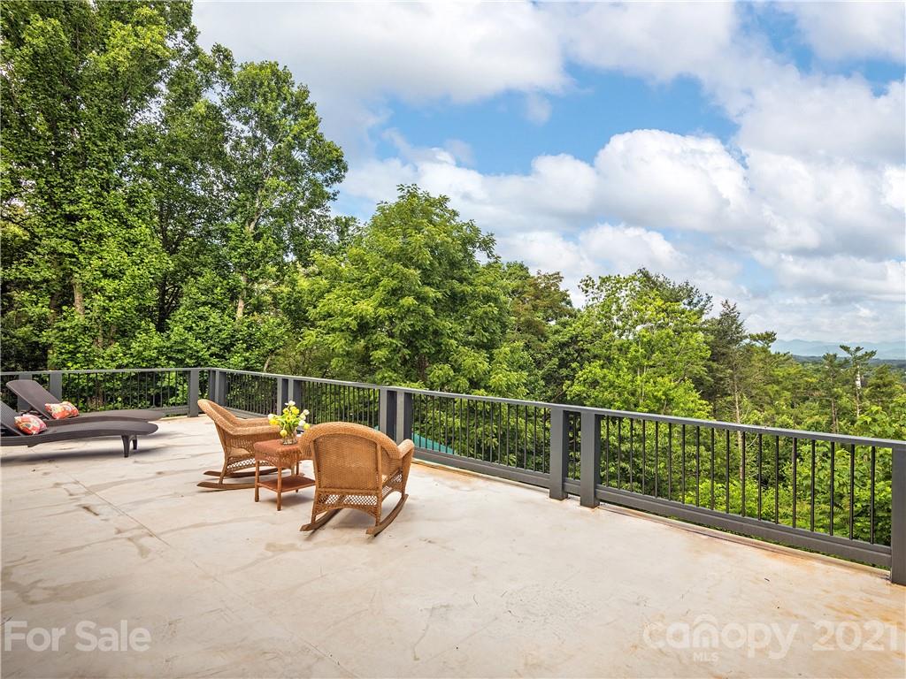 930 Country Club Road Asheville, NC 28804 - Photo 26 of 47 a view of a terrace with a bench