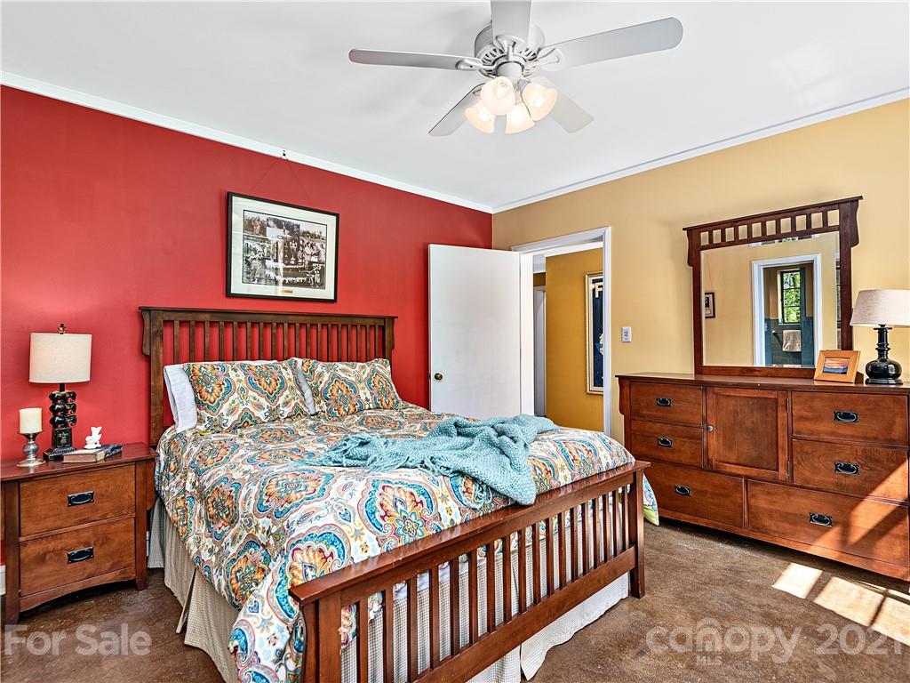 930 Country Club Road Asheville, NC 28804 - Photo 27 of 47 a bedroom with a bed and a dresser