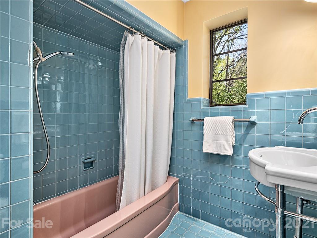 930 Country Club Road Asheville, NC 28804 - Photo 28 of 47 a bathroom with a tub shower and sink